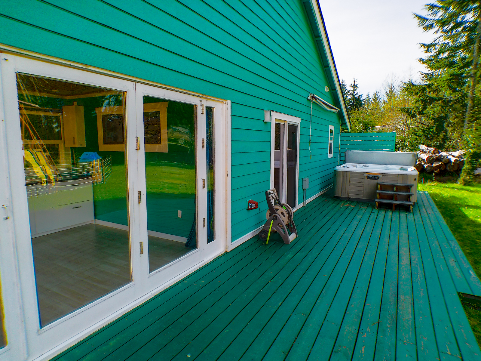 The back deck can be accessed from the master bedroom and the sunroom, with easy access to the hot tub.
