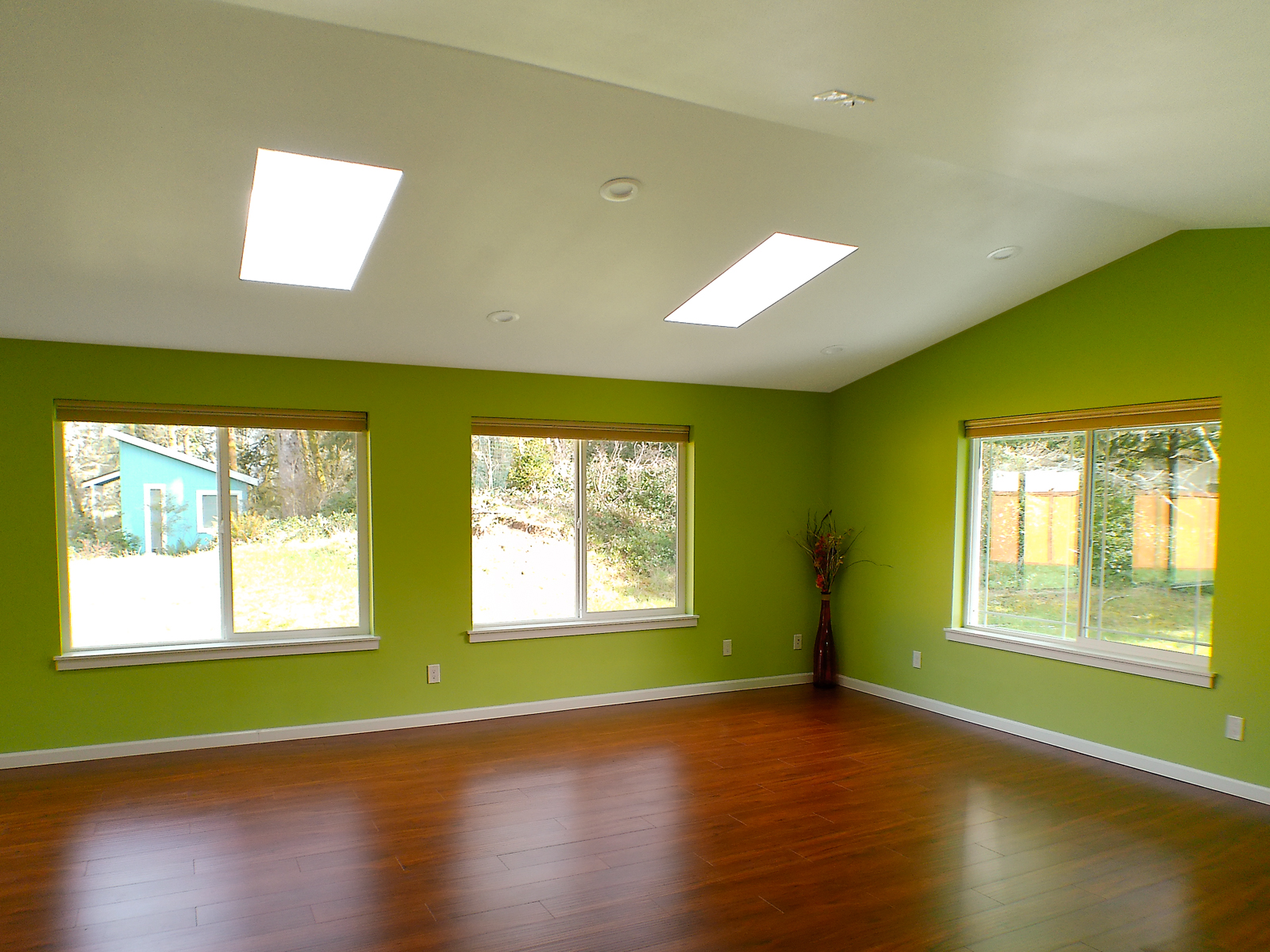 Bright windows and skylights flood the space with natural light, with views opening to the backyard and the detached studio on the second lot.