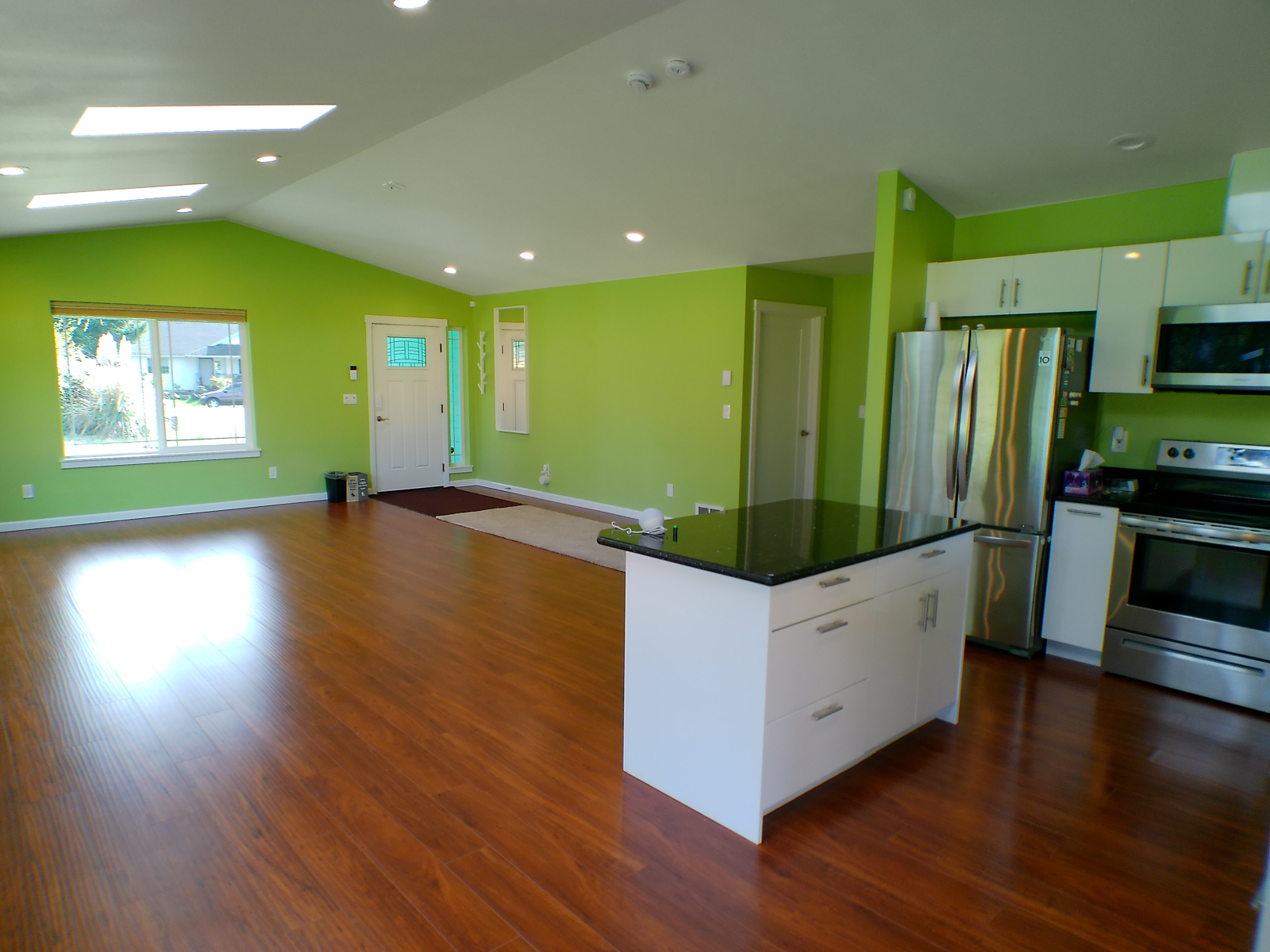 An open-plan layout unites the kitchen and living room, creating a warm, connected space where everyday moments are naturally shared.