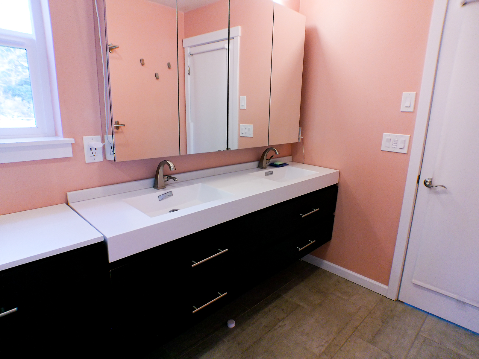 The double vanity and large mirror create a modern, open feel. The elevated vanity design makes for an easy-to-clean space. Heated floors with a smart programmable thermostat add a touch of everyday luxury.